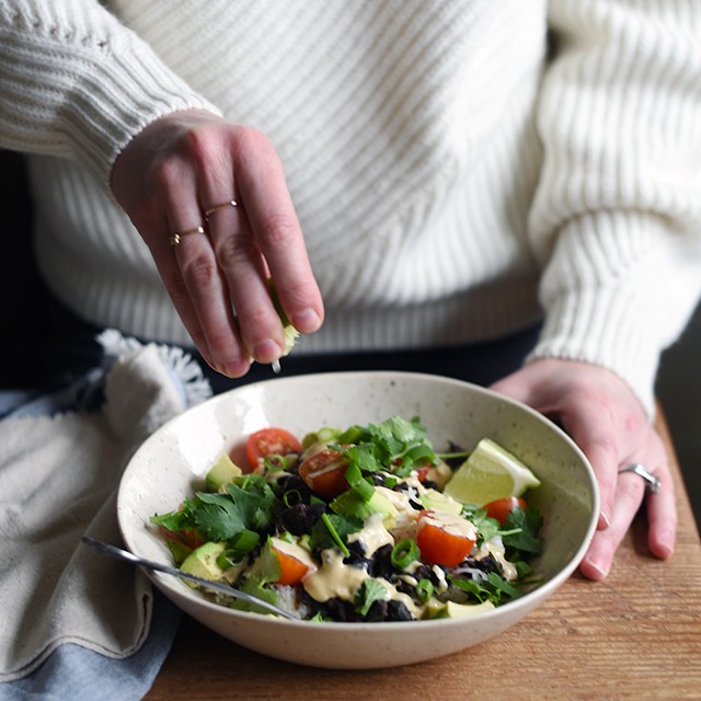 Turntable Kitchen shares a recipe for vegetarian (and vegan) Burrito Bowls with Cumin Lime Crema from A Couple Cook's new cookbook