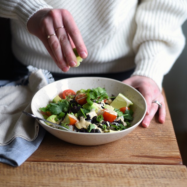 Turntable Kitchen shares a recipe for vegetarian (and vegan) Burrito Bowls with Cumin Lime Crema from A Couple Cook's new cookbook