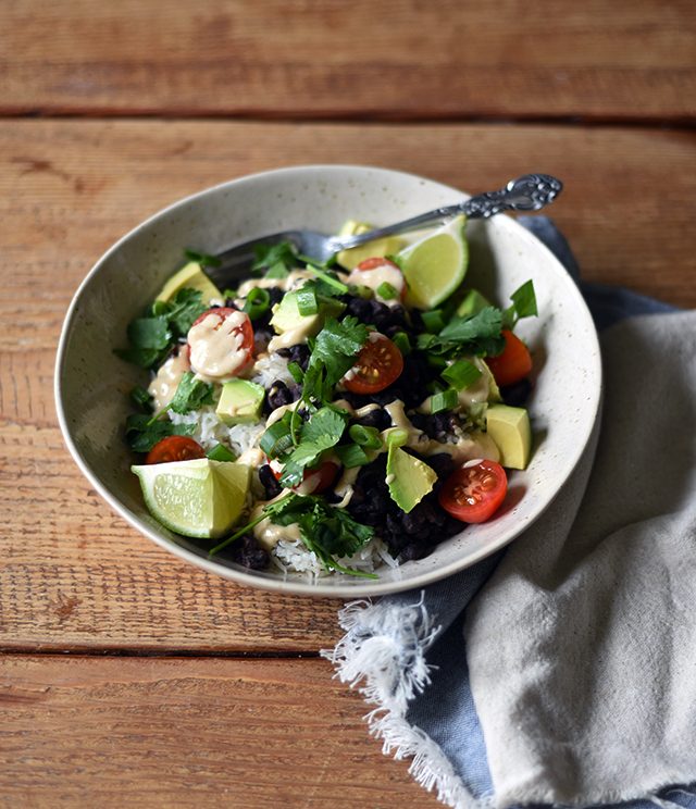 Turntable Kitchen shares a recipe for vegetarian (and vegan) Burrito Bowls with Cumin Lime Crema from A Couple Cook's new cookbook