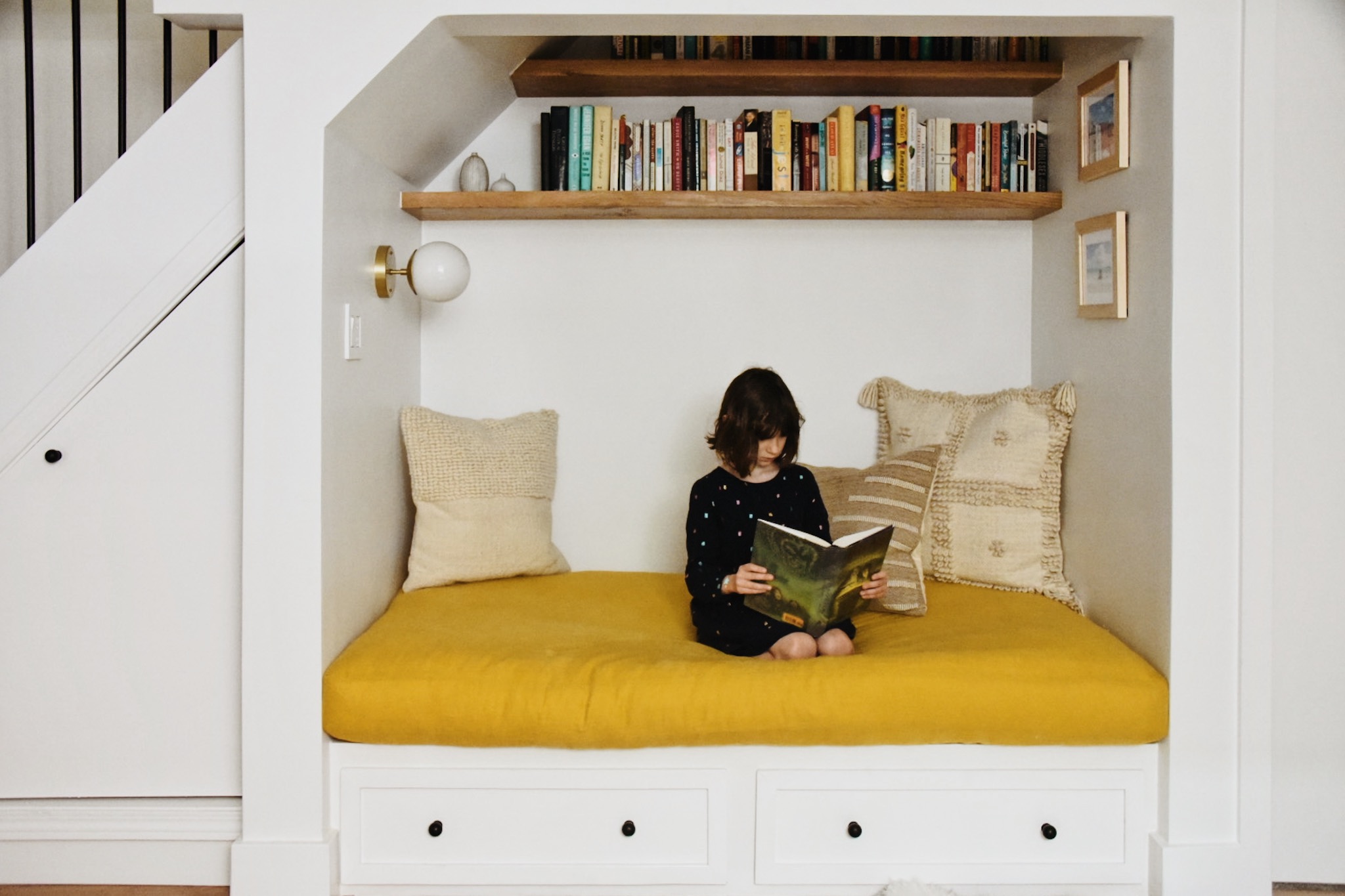 How a Seattle family of five turned a dark family basement in their 1930s tudor into a bright and airy multi-purpose workspace and playroom (with a cozy under stair reading nook!). 